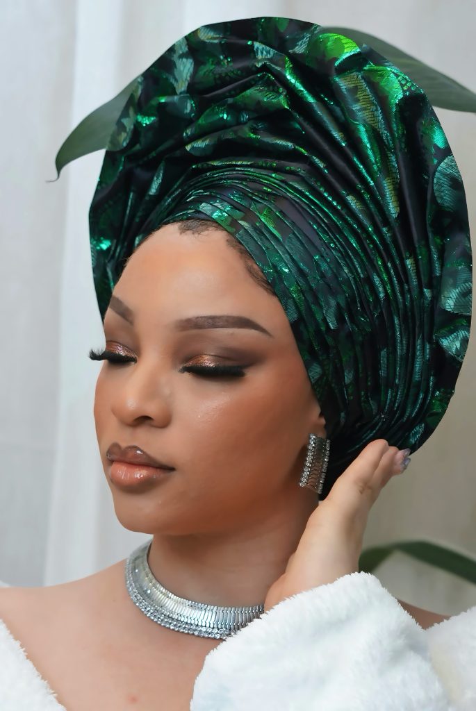 Event makeup with green gele in Ikeja
